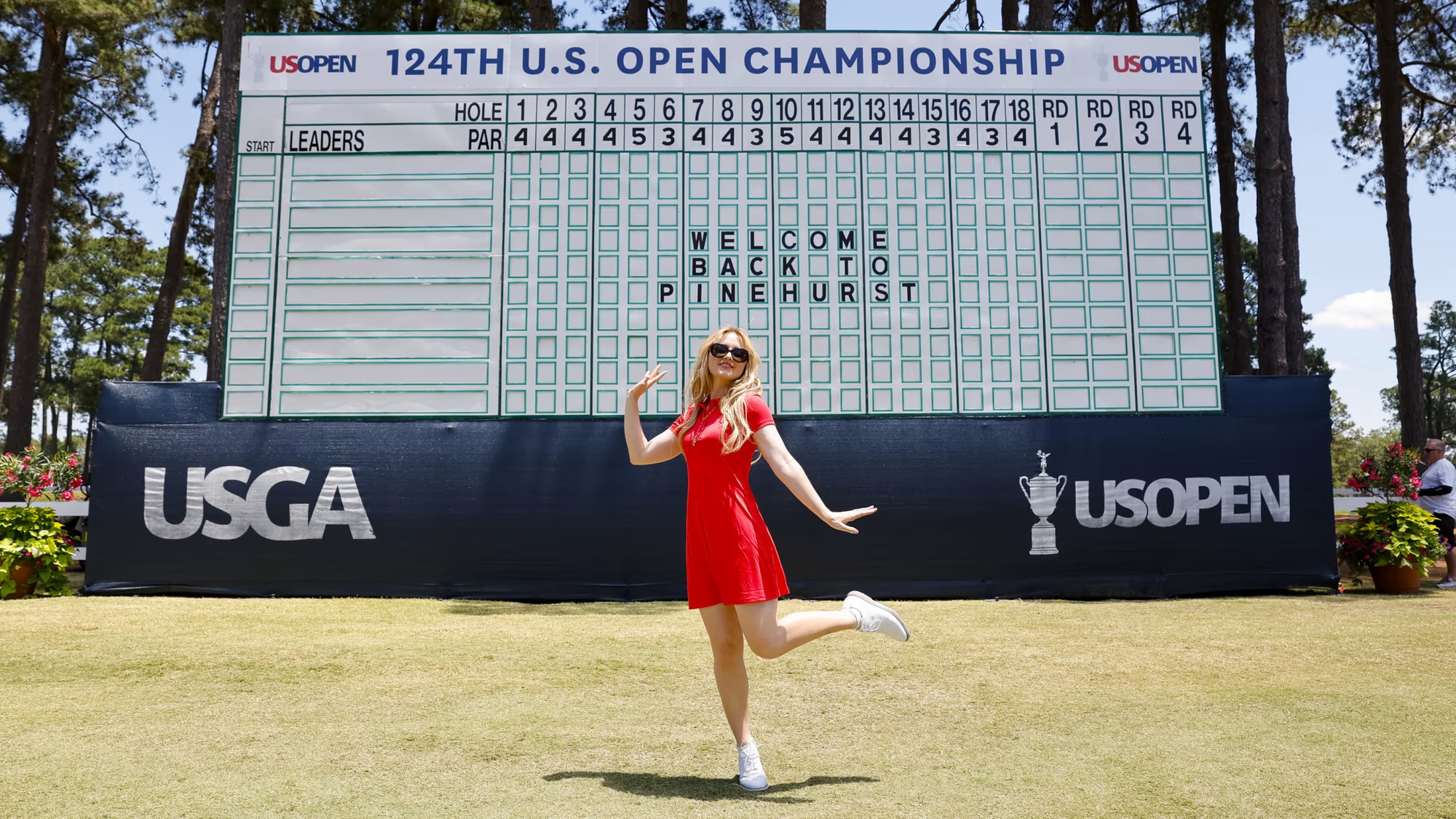 Actress Kathryn Newton poses in front of a scoreboard at Pinehurst on Tuesday. (Image via Gettyimages)
