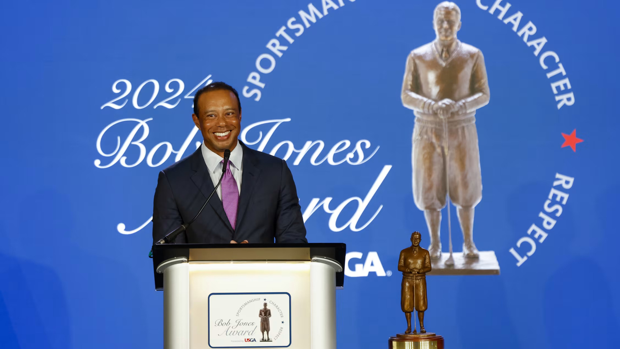 Tiger Woods gives remarks after receiving the 2024 USGA Bob Jones Award, the highest honor bestowed by the Association. The ceremony took place Tuesday night at the Carolina Hotel at Pinehurst. (Image via Gettyimages)