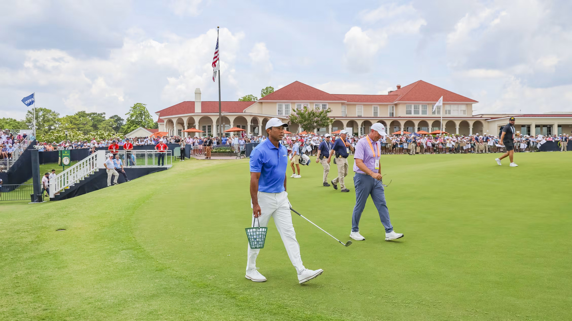 Three-time champion Tiger Woods carries a basket of balls to the practice facility at Pinehurst. (Image via Gettyimages)