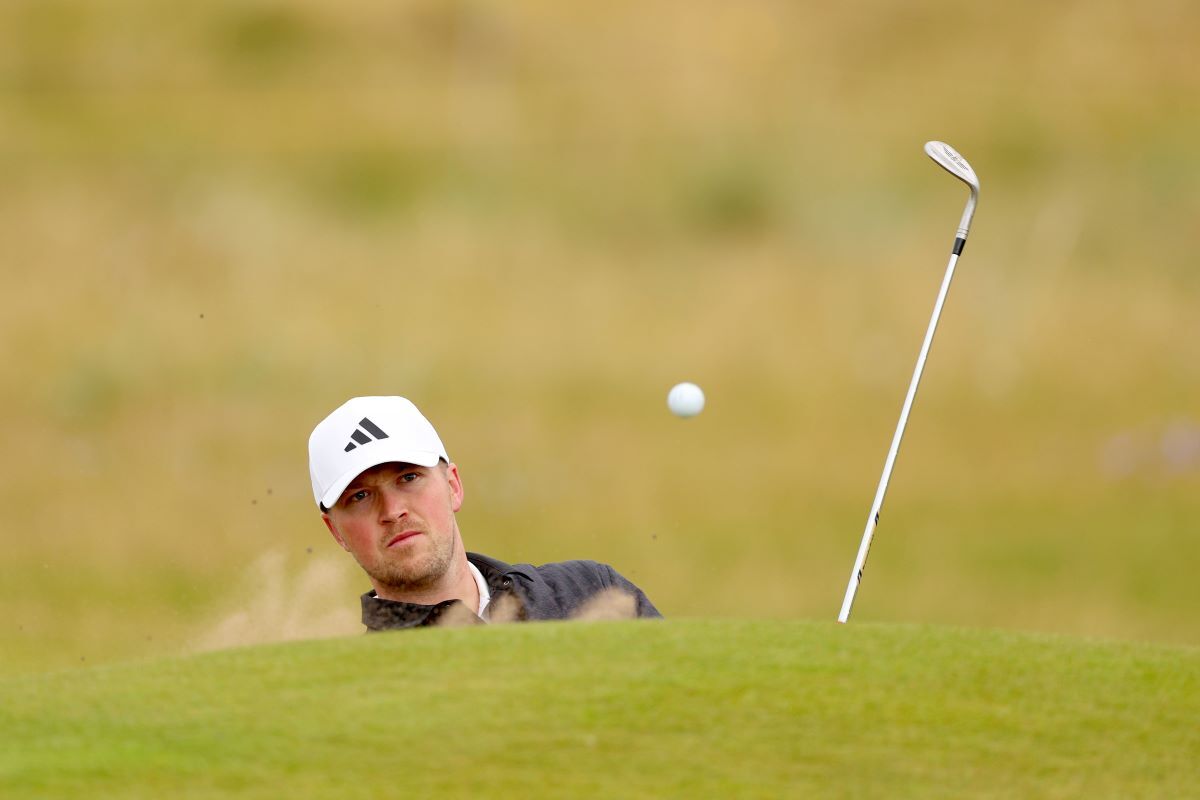 Richard Mansell of England plays a bunker shot on the second. (Image via Gettyimages)