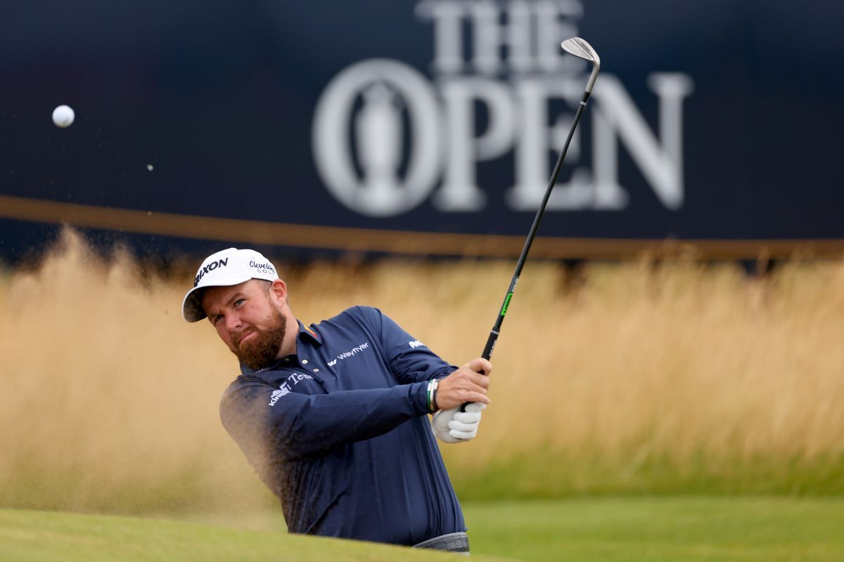 Shane Lowry of Ireland plays a bunker shot on the first hole. (Image via Gettyimages)
