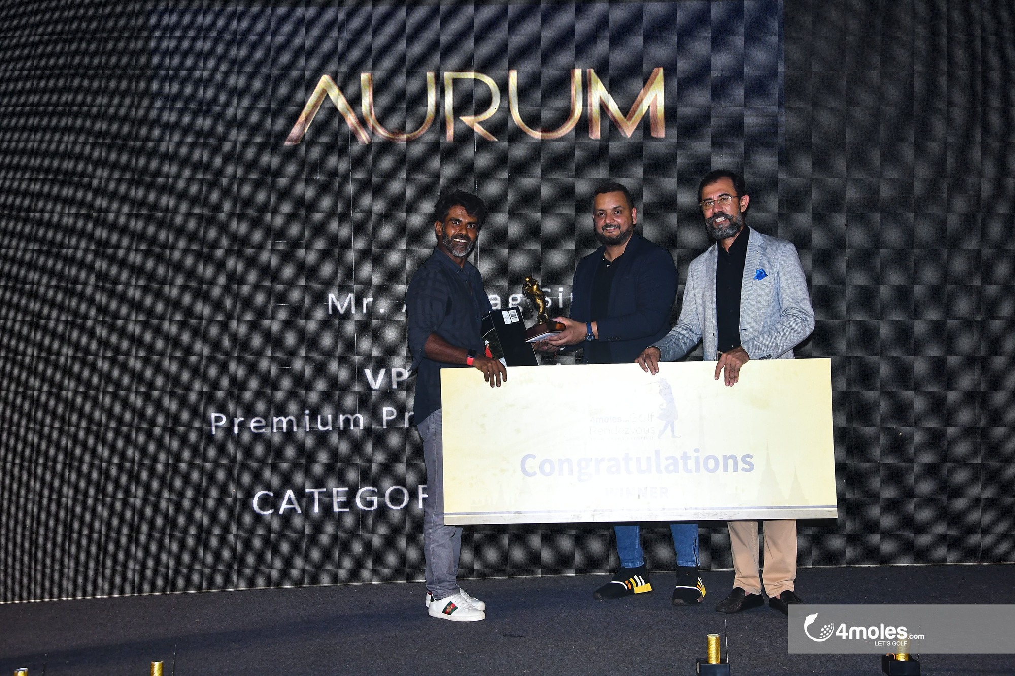 Bhavya Sharma getting prize of  GOLF GANESHA + Trip to Bangkok + Srixon Travel Bag + Truefitt & Hill Voucher by  Mr. Anurag Singh – VP Marketing – Premium Products Dinesh Thakur