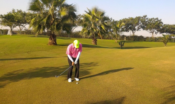 Golfers played in the warm yellow glow