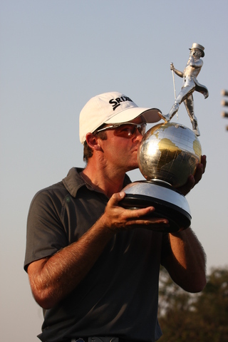 Mark Brown with his prized possession, the Johnnie Walker Classic 2008 trophy. 