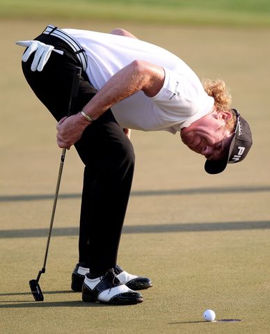 Miguel Angel Jimenez of Spain looks to see if his ball will drop into the hole on the par five 10th hole during the first round.