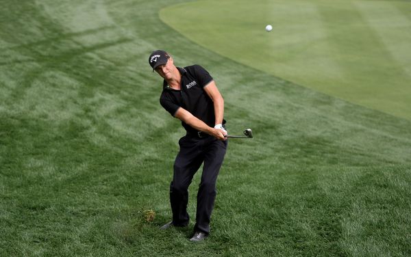 Alexander Noren of Sweden plays a chip shot on the ninth hole during the first round.