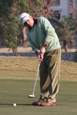 Mr. Munjal, taking a practice swing before his put.