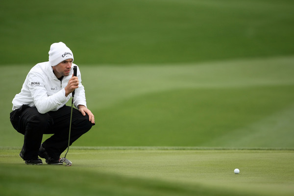 Oliver Wilson (ENG) lines up his putt on Day 1