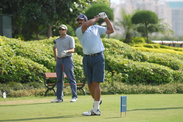 Amit Luthra teeing off, with Saurabh Rana in the back ground.