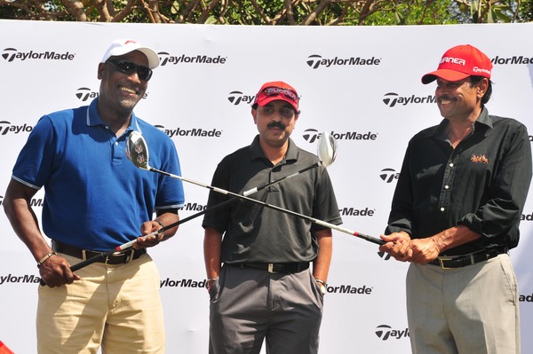 Viv Richards and Kapil Dev cross their drivers as Ateet Gaur (center) looks on