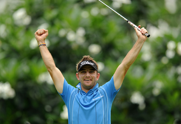 Jbe Kruger of South Africa exults after making a putt during Round 2