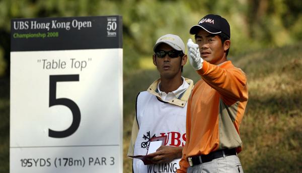 Liang Wen Chong, with his caddy.
