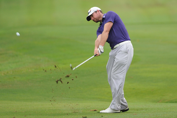 Marcus Both of Australia hits an iron-shot at Round 1 enroute to a 67 score