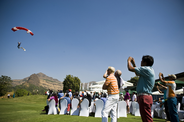 A skydiver descends infront of the crowd during the opening ceremony