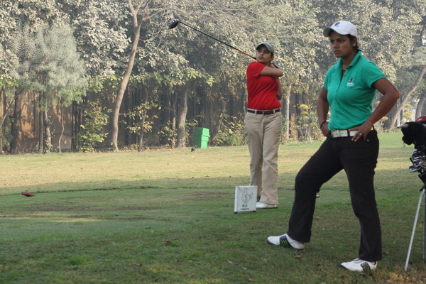 Nitika Jadeja off the tee, over looked by Nikki Ponappa.