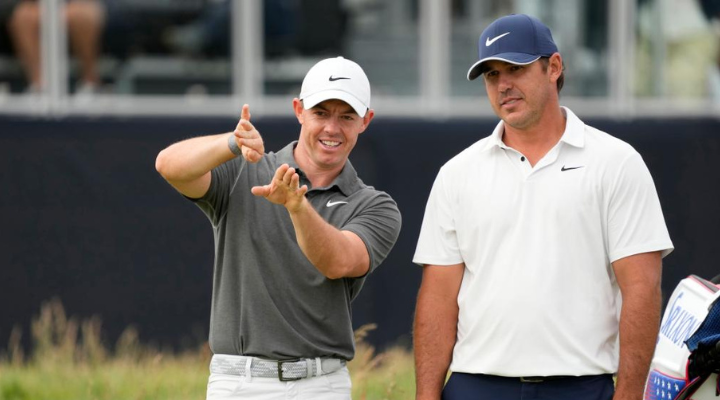 Rory McIlroy and Brooks Koepka (LIV player) talk on the 12th hole during the first round. Read more on 4moles.com 